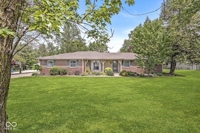 single story home featuring a front yard and brick siding