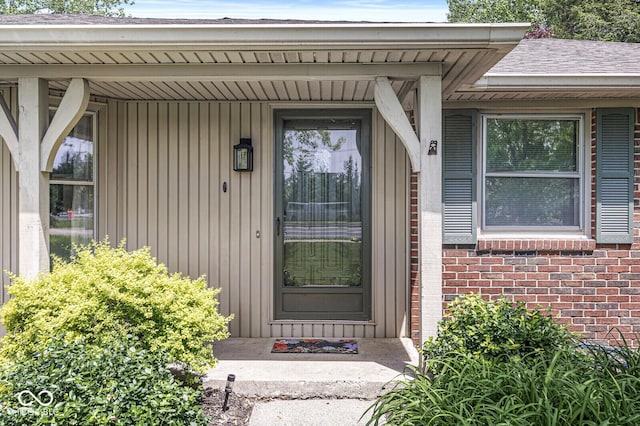 view of exterior entry featuring brick siding