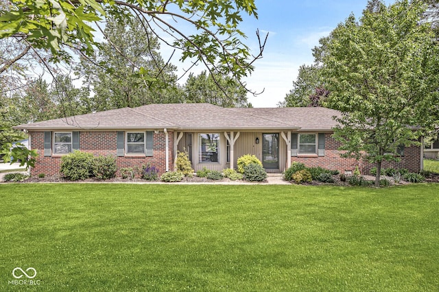 ranch-style house with a front yard, brick siding, and roof with shingles