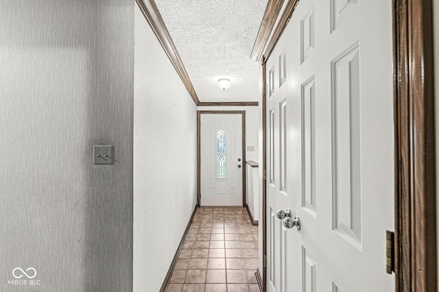 doorway featuring ornamental molding, a textured ceiling, and light tile patterned floors