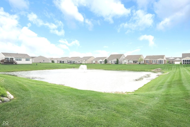 view of property's community featuring a lawn, a water view, and a residential view