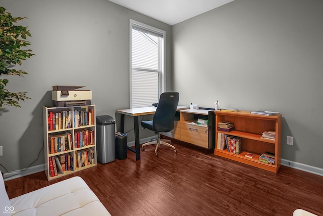 office space with baseboards and wood finished floors