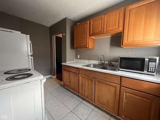 3541 Orchard Ave, Indianapolis, IN 46218 - kitchen featuring a sink, brown cabinets, white appliances, and light countertops