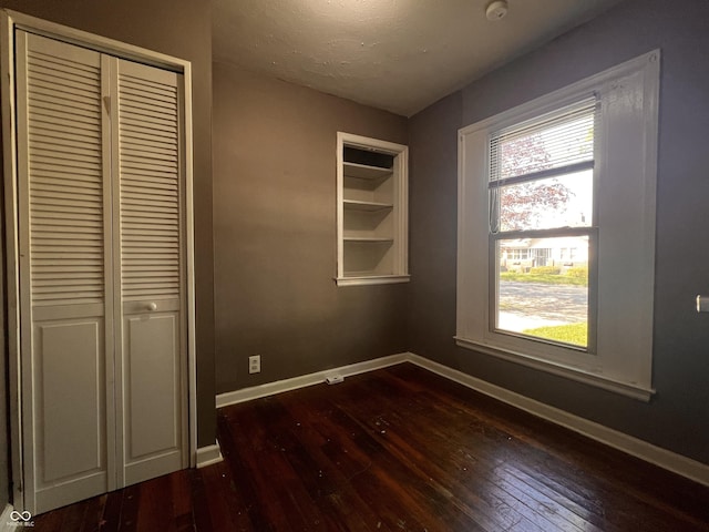 3541 Orchard Ave, Indianapolis, IN 46218 - interior space with a closet, baseboards, and dark wood-style floors