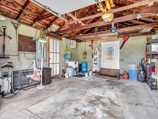 garage featuring concrete block wall and a sink