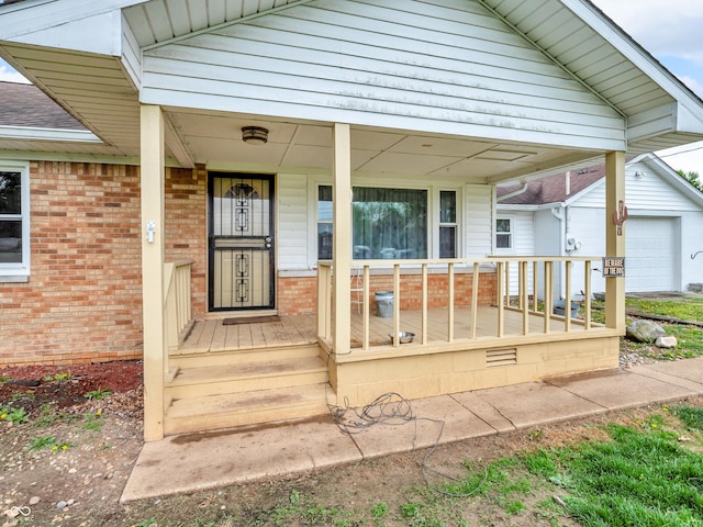 entrance to property with covered porch and brick siding