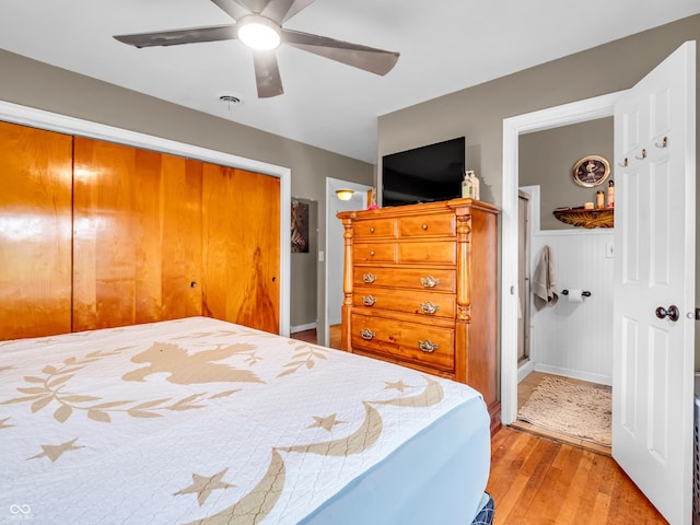 bedroom with a ceiling fan, a closet, and light wood-style flooring