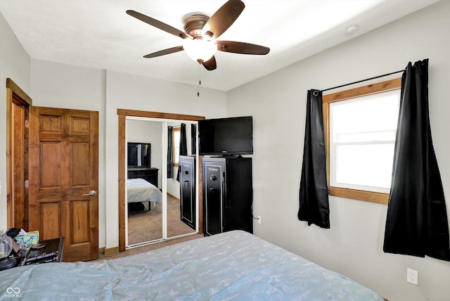 carpeted bedroom featuring a closet and ceiling fan