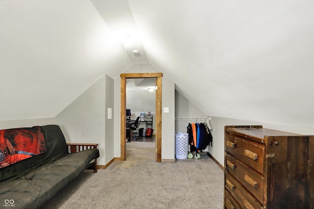 additional living space with baseboards, vaulted ceiling, and carpet