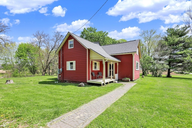 back of property featuring a yard, crawl space, and a shingled roof