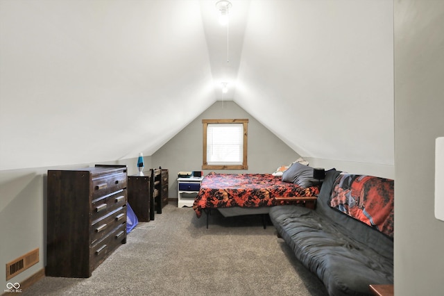 carpeted bedroom featuring lofted ceiling and visible vents