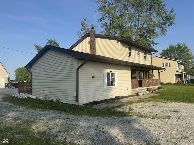 3008 N Michigan Rd, Shelbyville, IN 46176 - rear view of house with covered porch and a chimney