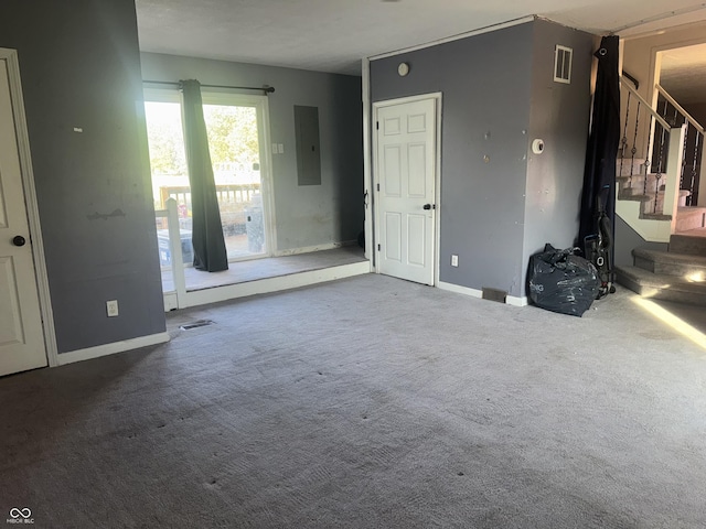 3008 N Michigan Rd, Shelbyville, IN 46176 - unfurnished living room featuring carpet floors, visible vents, stairway, and electric panel