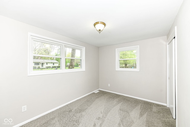 unfurnished bedroom featuring baseboards, a closet, and carpet