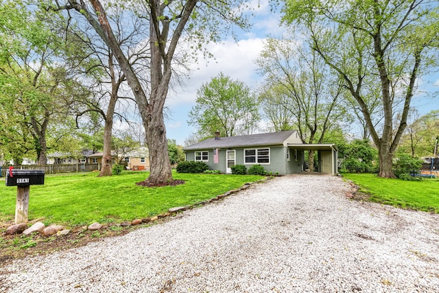 single story home featuring a front yard, gravel driveway, and fence