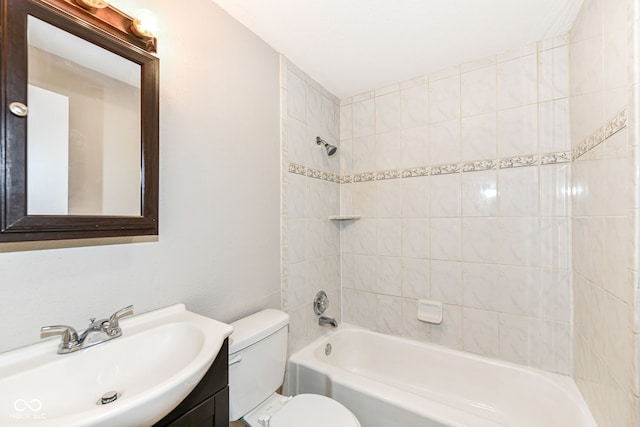 bathroom with toilet, vanity, and  shower combination