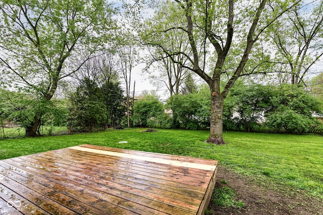 wooden deck with a lawn