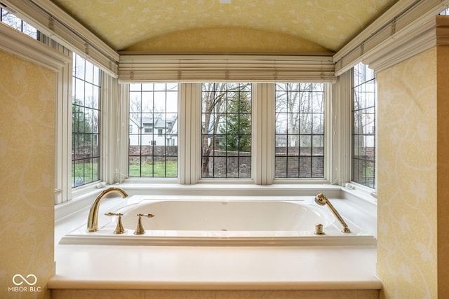 bathroom with a garden tub and lofted ceiling