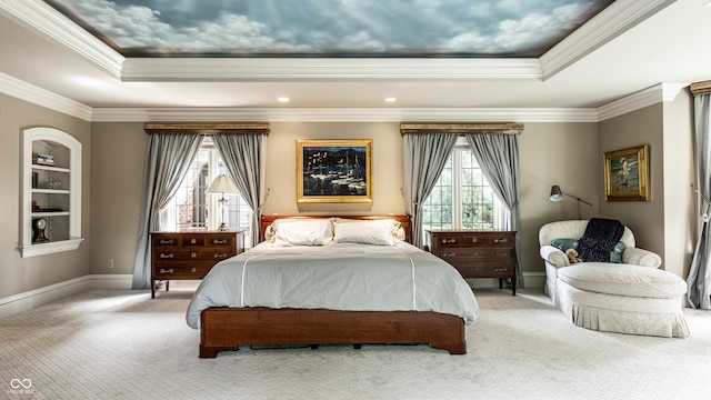bedroom with multiple windows, a raised ceiling, and light carpet