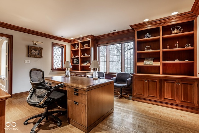 office with crown molding, baseboards, visible vents, and light wood-type flooring