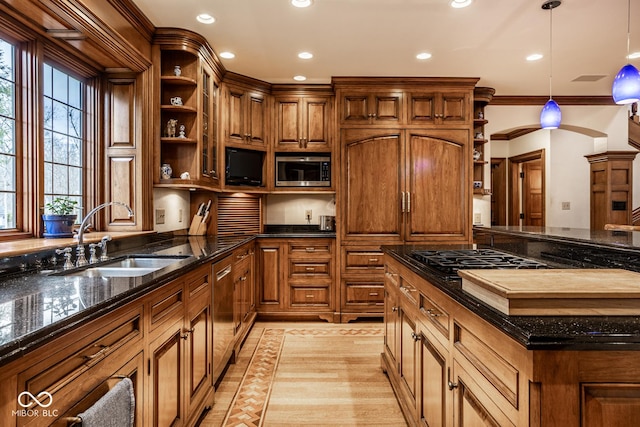 kitchen featuring a sink, open shelves, stainless steel appliances, and brown cabinetry