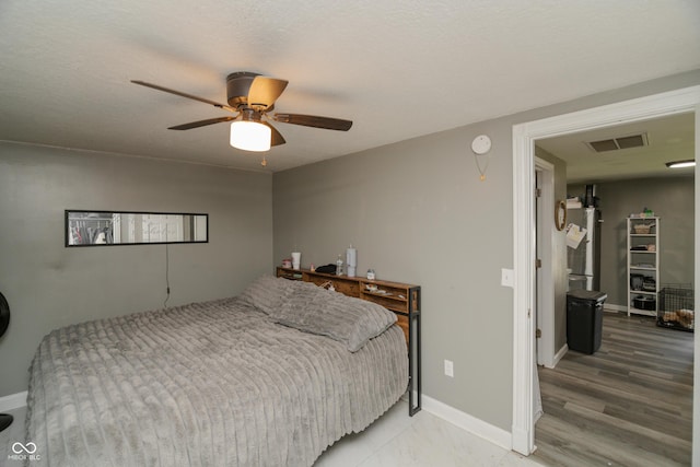 bedroom featuring baseboards, ceiling fan, freestanding refrigerator, and visible vents