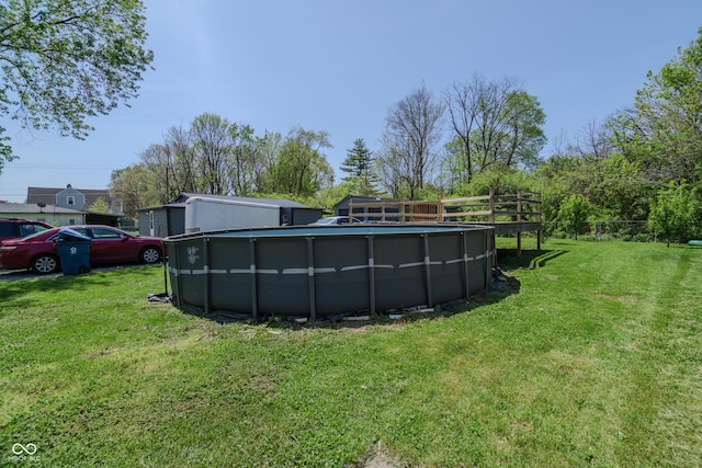 outdoor pool featuring a yard