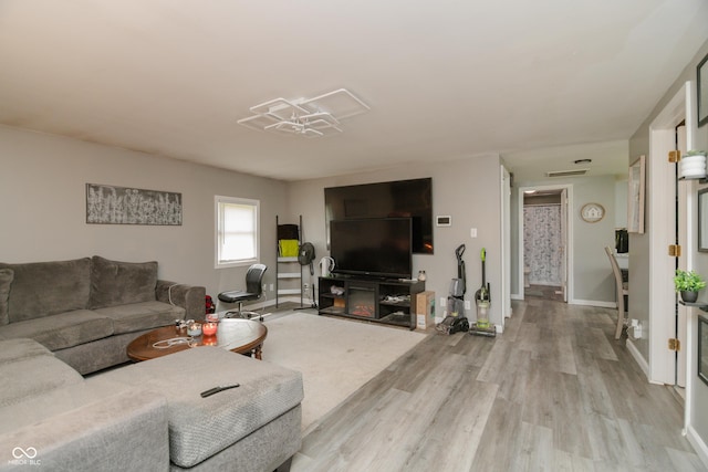 living room with baseboards and wood finished floors