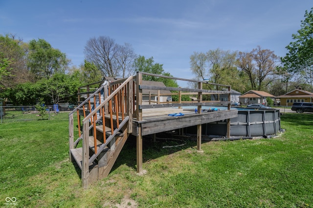 deck featuring a lawn, fence, and an outdoor pool