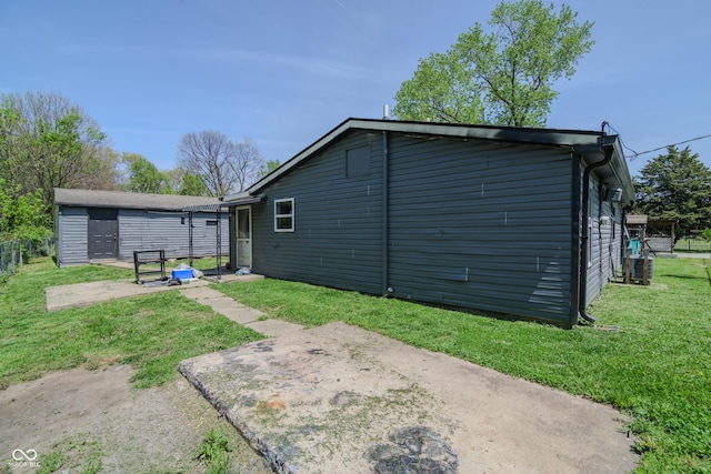 back of house with a patio and a yard