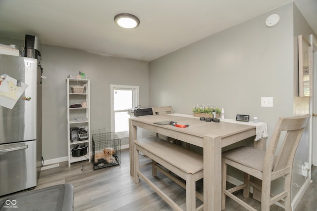 dining room featuring baseboards and wood finished floors