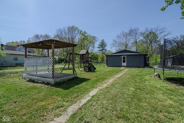 view of yard featuring a playground, fence, and a trampoline