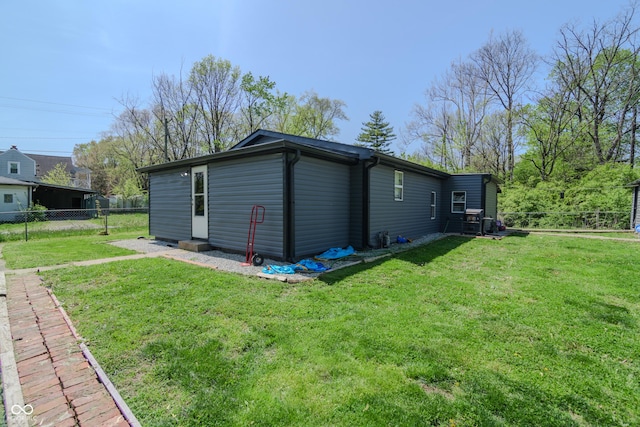 exterior space with fence and a yard