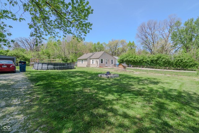 view of yard with fence and an outdoor pool