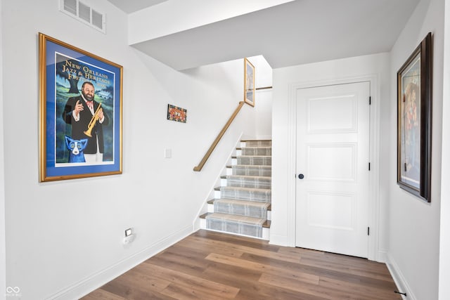 interior space with visible vents, baseboards, and wood finished floors