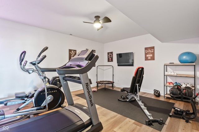 workout area featuring baseboards, ceiling fan, and wood finished floors