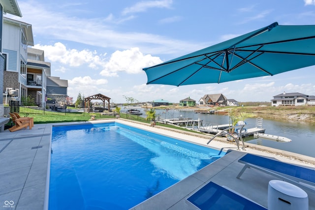 view of pool with fence, a fenced in pool, a gazebo, and a water view