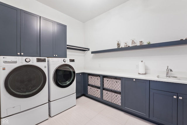 laundry area featuring a sink, independent washer and dryer, and cabinet space