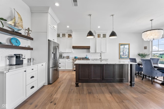kitchen featuring white cabinets, stainless steel appliances, recessed lighting, decorative backsplash, and visible vents