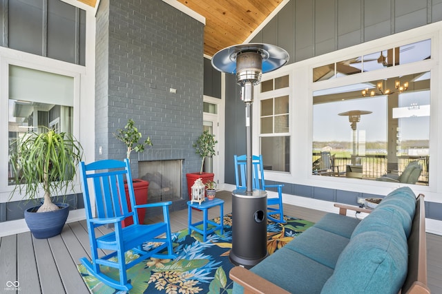 wooden deck featuring a brick fireplace