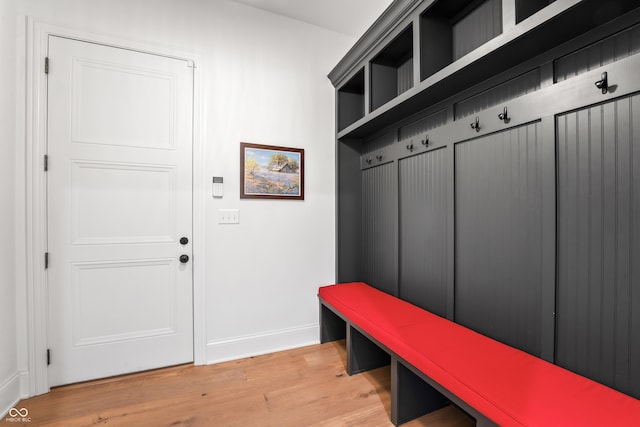 mudroom with light wood-style floors and baseboards