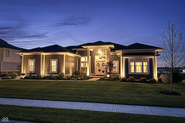 prairie-style house with board and batten siding and a front yard