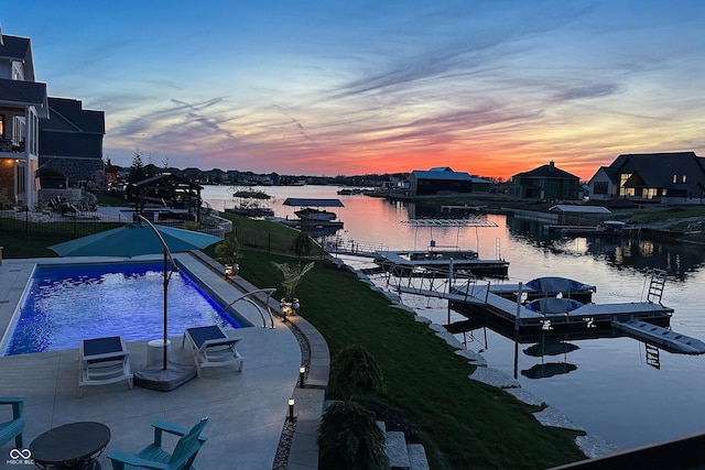 exterior space featuring a water view, a patio, and a boat dock