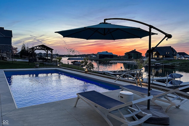 view of swimming pool with a fenced in pool, a water view, and fence
