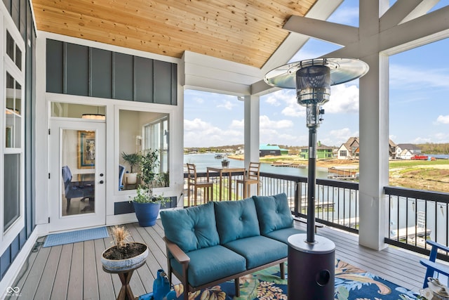 sunroom / solarium with a water view