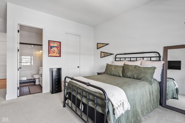 carpeted bedroom with ensuite bath