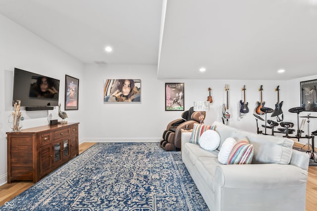 living room featuring baseboards, recessed lighting, and wood finished floors