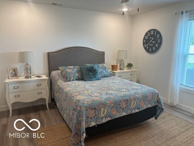 1511 Coen Ct, Columbus, IN 47201 - bedroom with wood finished floors, baseboards, visible vents, and multiple windows