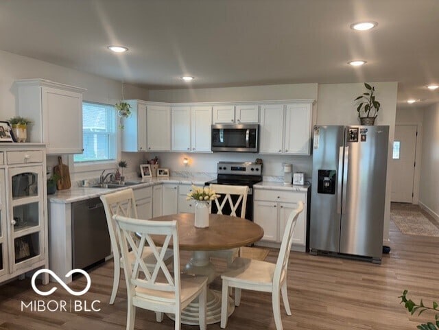 1511 Coen Ct, Columbus, IN 47201 - kitchen featuring light countertops, appliances with stainless steel finishes, and white cabinetry