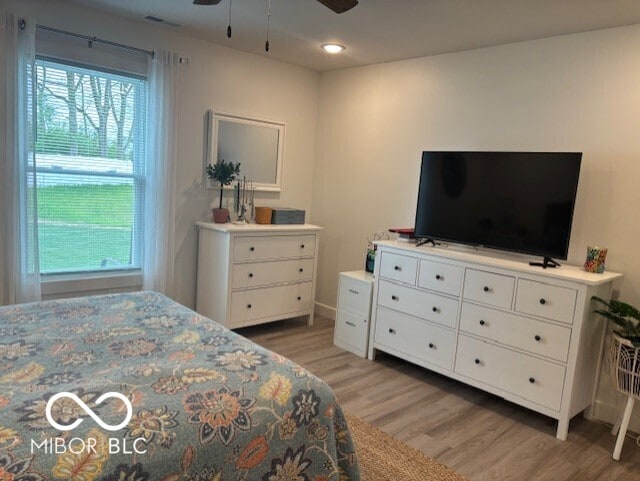 1511 Coen Ct, Columbus, IN 47201 - bedroom featuring multiple windows, ceiling fan, light wood-style flooring, and visible vents